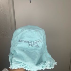 This is a vintage solid teal blue fishing cap with writing logo on the front .